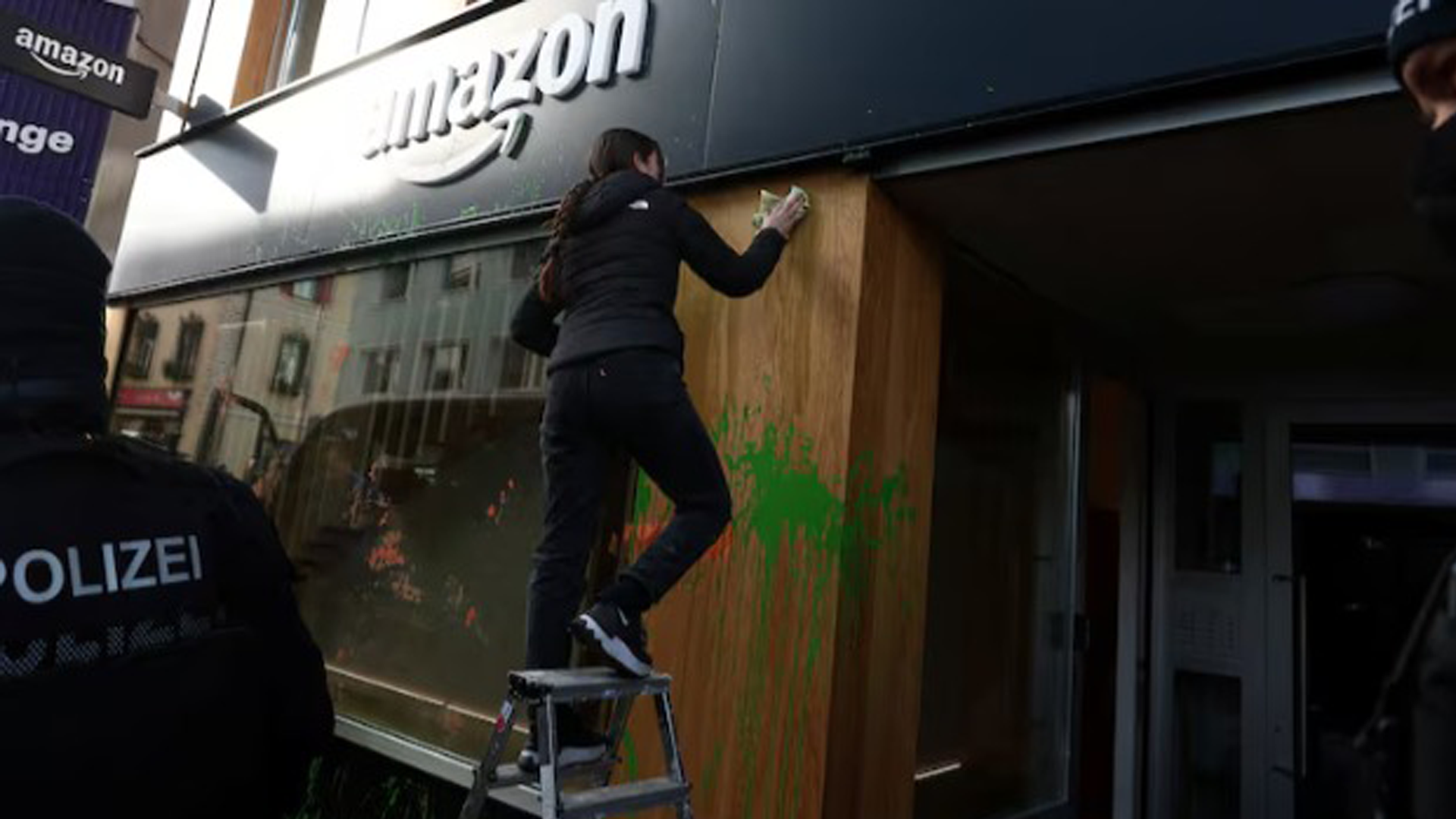 Climate Activists Spray-Paint Amazon Base at Davos with Green and Orange